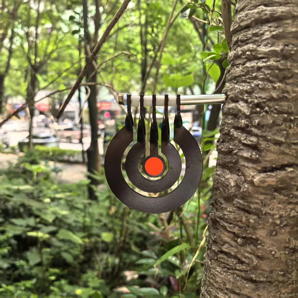 Shooting practice with a three – ring tree – inserted rotating pendulum target made of 3 – millimeter – thick metal Shooting practice with a three – ring tree – inserted rotating pendulum target made of 3 – millimeter – thick metal