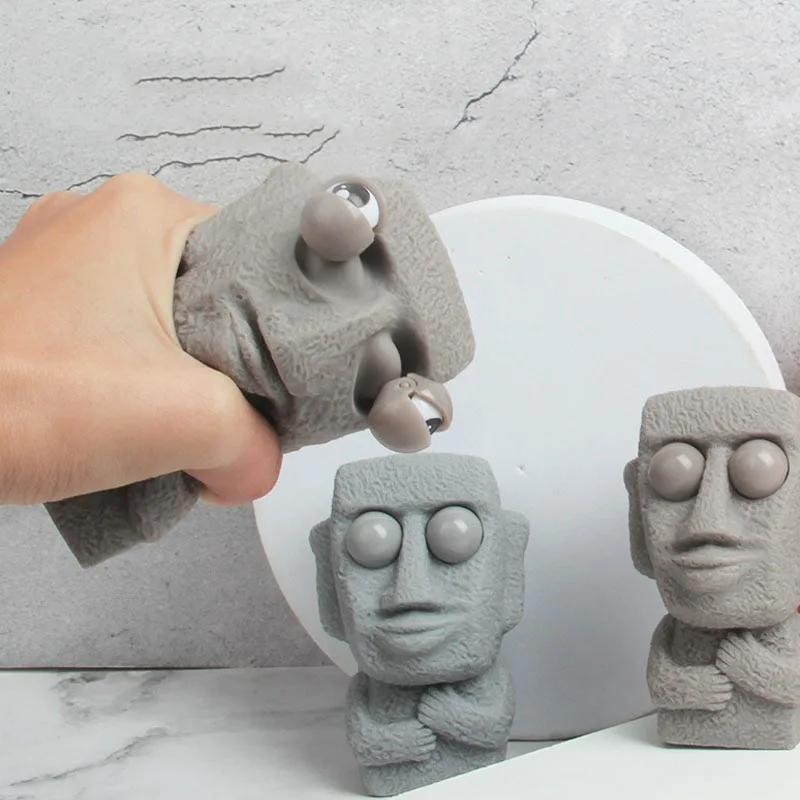 Stone Man Releases Stress Toy Slowly Rebounds Soft Moai Statue Squeeze Eyes Interested Expression Relaxes Stress